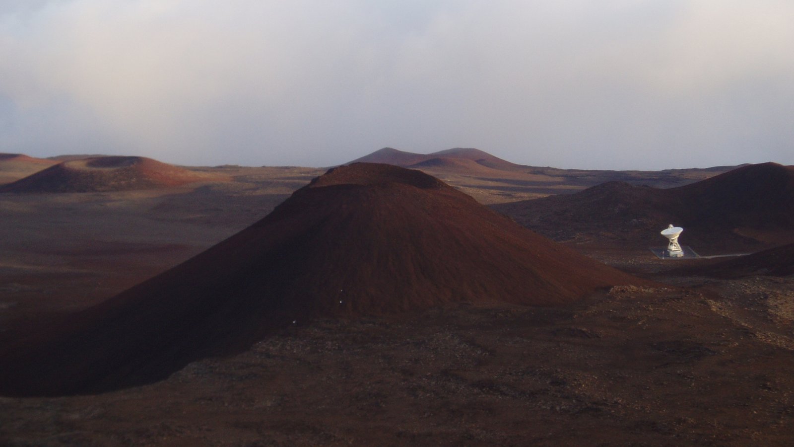 Volcanic cones and a radio telescope on Mauna Kea volcano in Hawaii