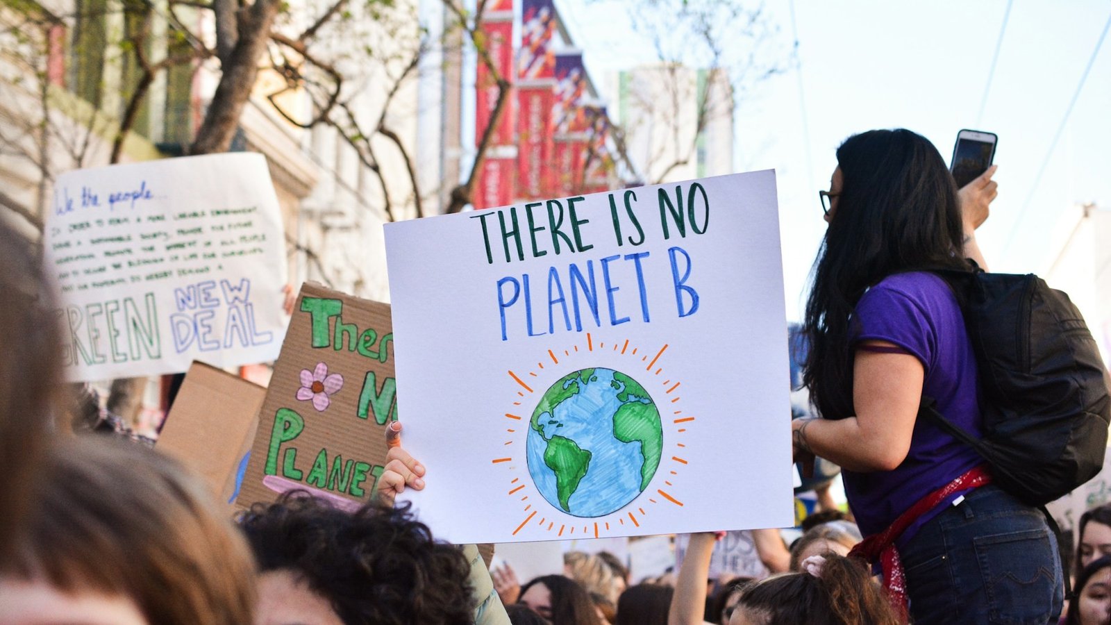 People protesting against climate change with a there is no planet b poster