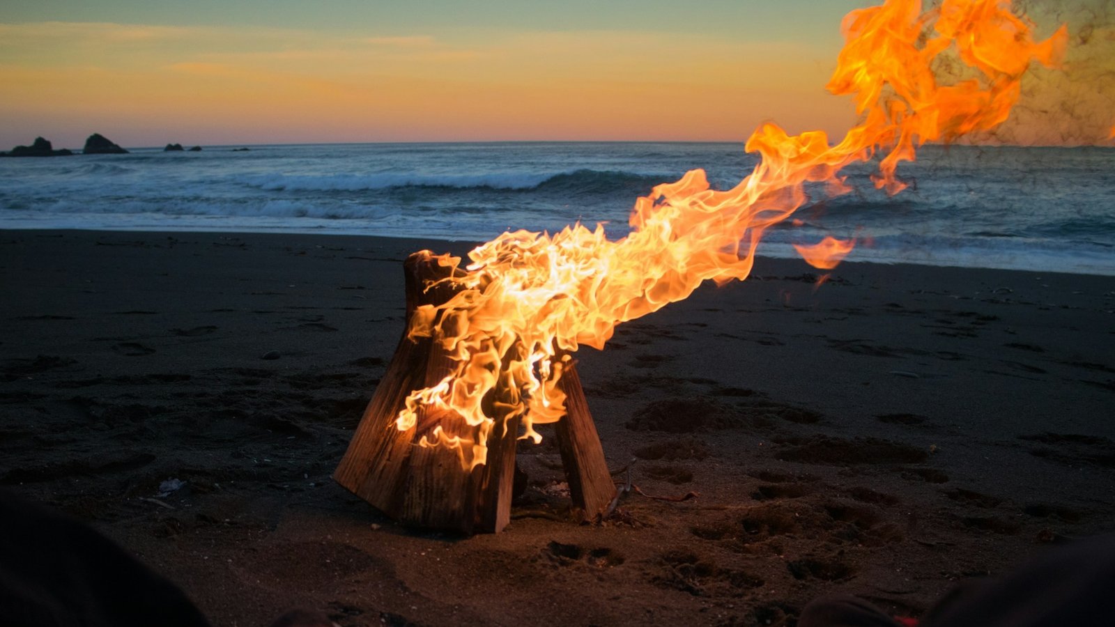 Bonfire on a beach with a beautiful sunset view