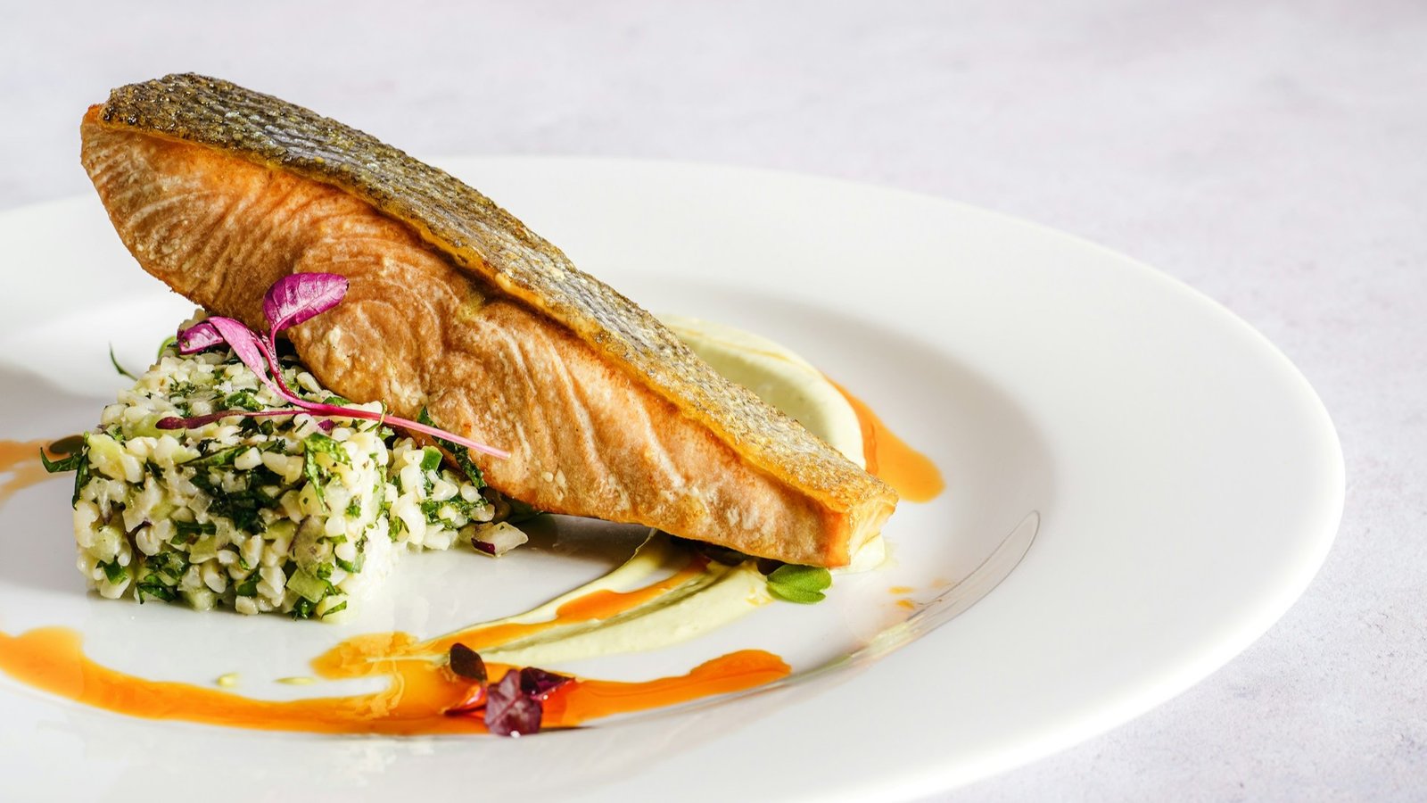 Salmon steak dish served on a white plate at a restaurant